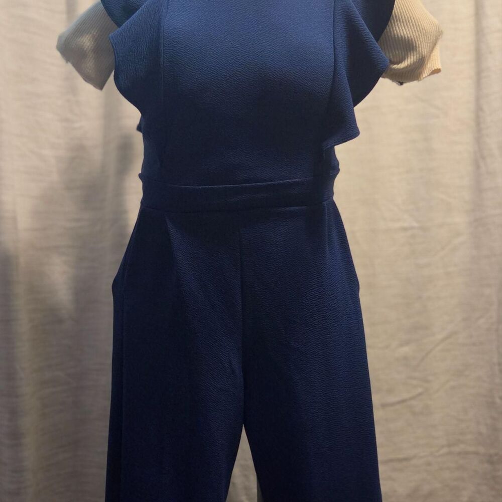 navy blue wide-leg jumpsuit with ruffle shoulder accents